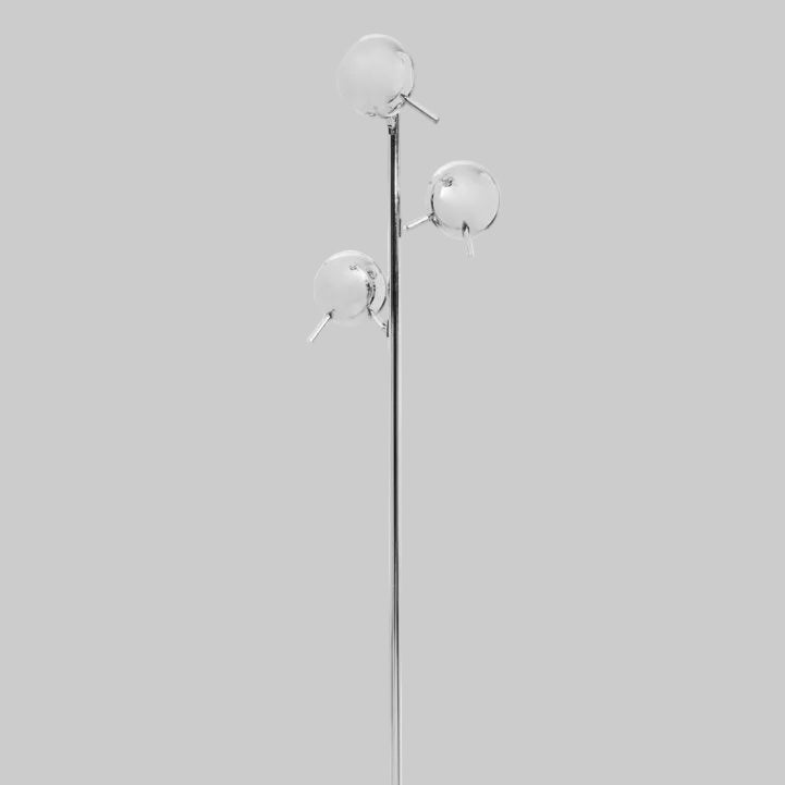 Modern floor lamp with three silver shades on a grey background