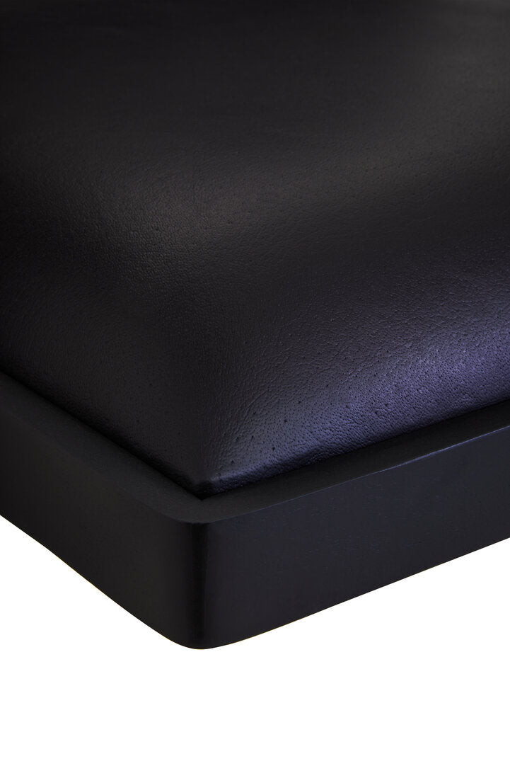 Black leather chair close up on a white background