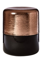 Decorative stool with bronze top and black base on a white background