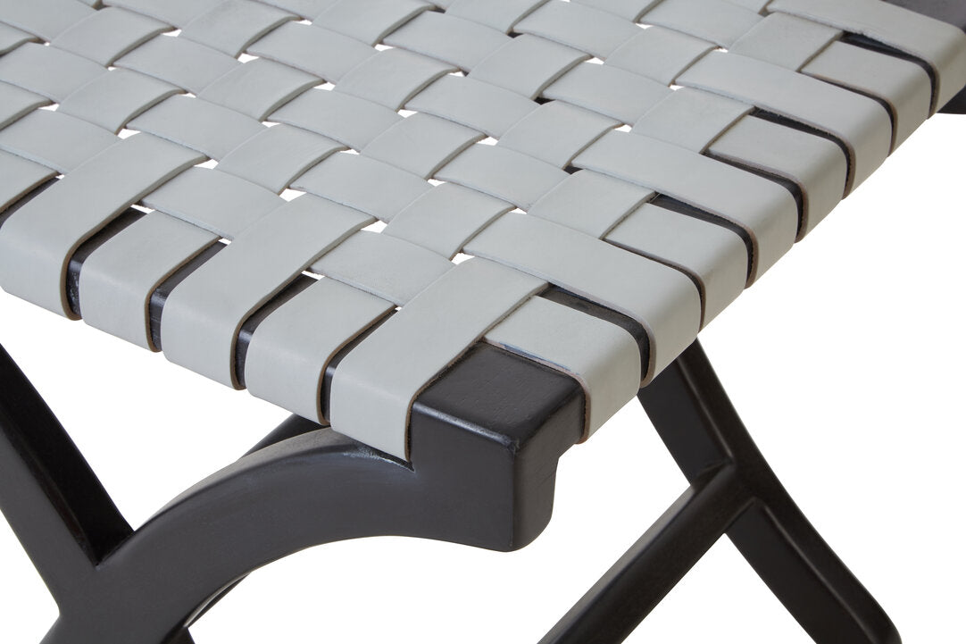 Close-up of a woven chair seat with a black wood frame on a white background