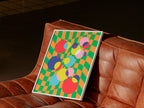 Checkerboard Bubbles Poster in white frame on leather couch