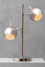 Modern table lamp with two silver spherical shades on a gray background