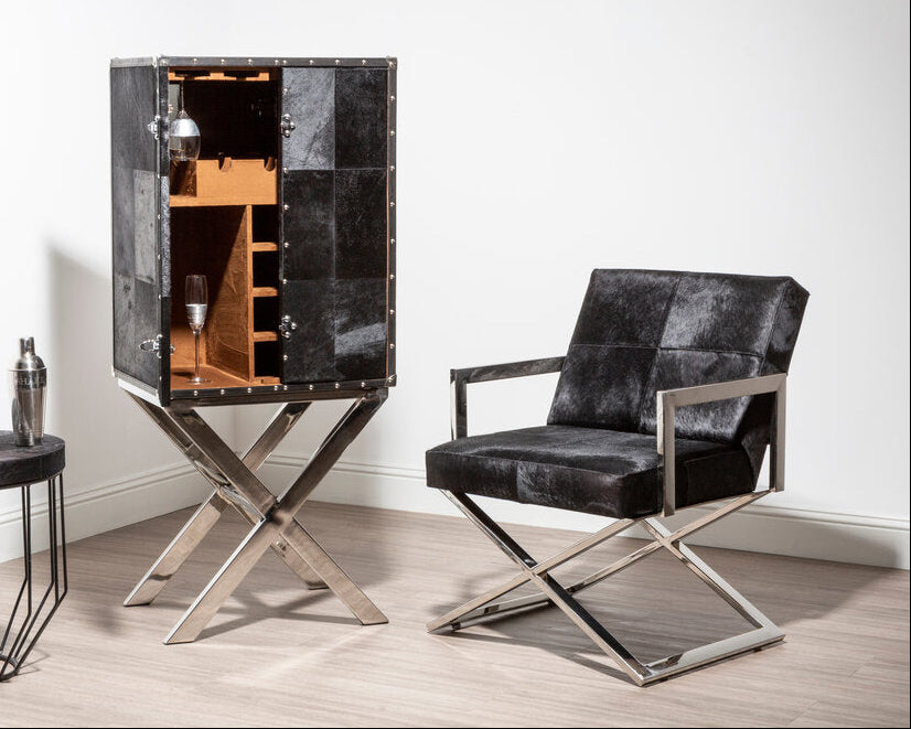 Chrome Cross Leg Chair with black upholstery next to cupboard