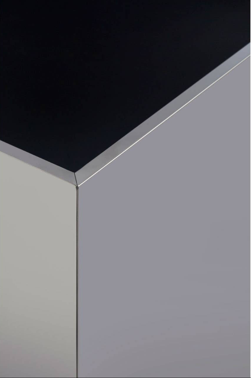 Corner of a black and silver rectangular side table