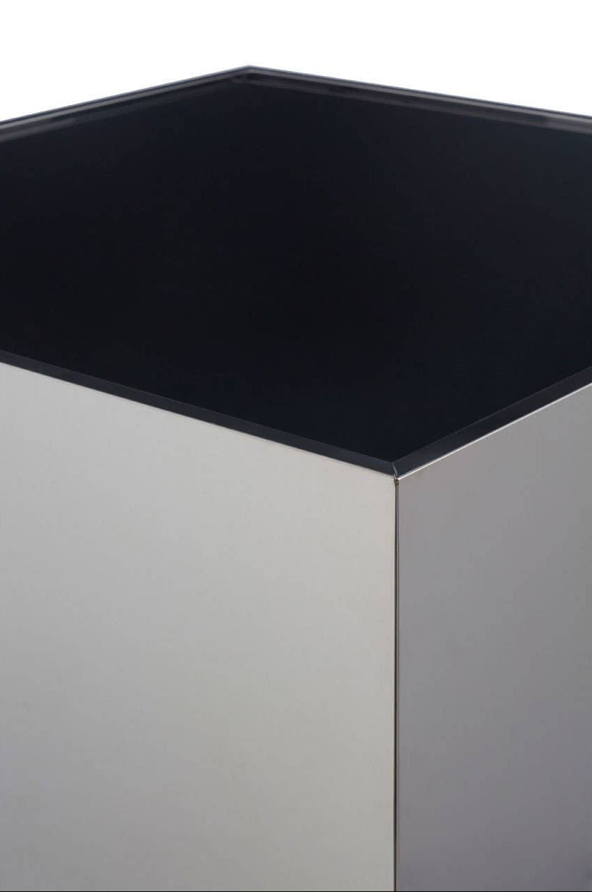 Square black glass top on a metallic base against a white background