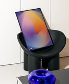 Colour Gradient Blur Poster in a Black Frame on a black chair