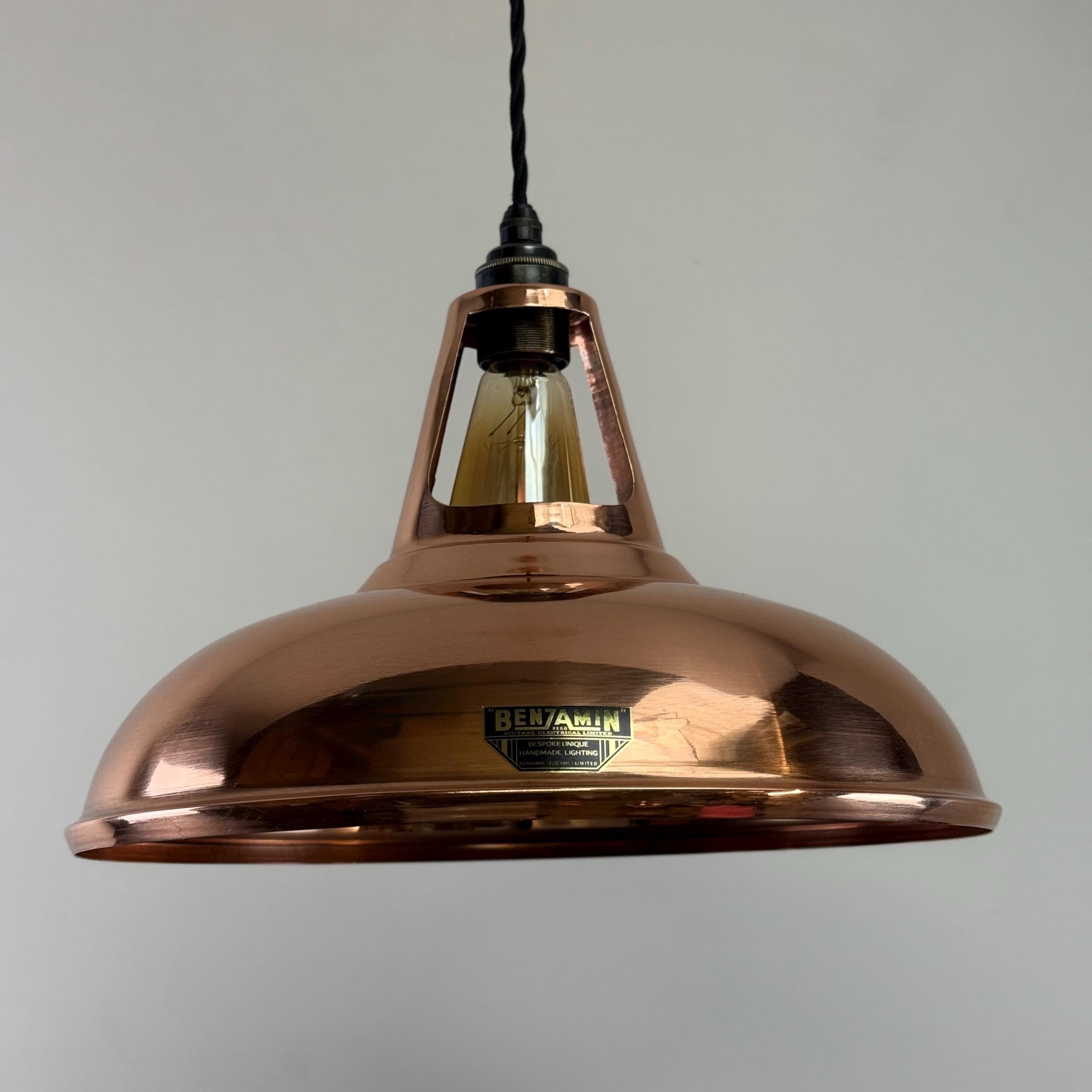 Copper pendant light with a visible brand logo on a gray background