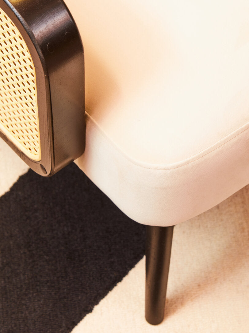 Close up of Cream Rattan Velvet Armchair