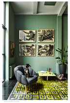Living room with green walls, gray armchair, yellow coffee table, and decorative elements.
