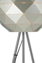 Geometrically patterned lamp with metallic legs on a white background