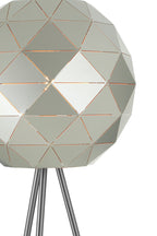 Geometrically designed lamp with metallic legs on a white background