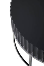 Detail of Round Black coffee table on stainless steel  base on white background