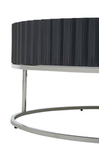 Side view of Round Black coffee table on stainless steel  base on white background