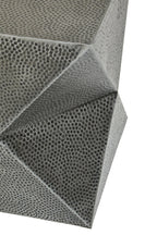 Close-up of a honeycomb-like metal on a white background