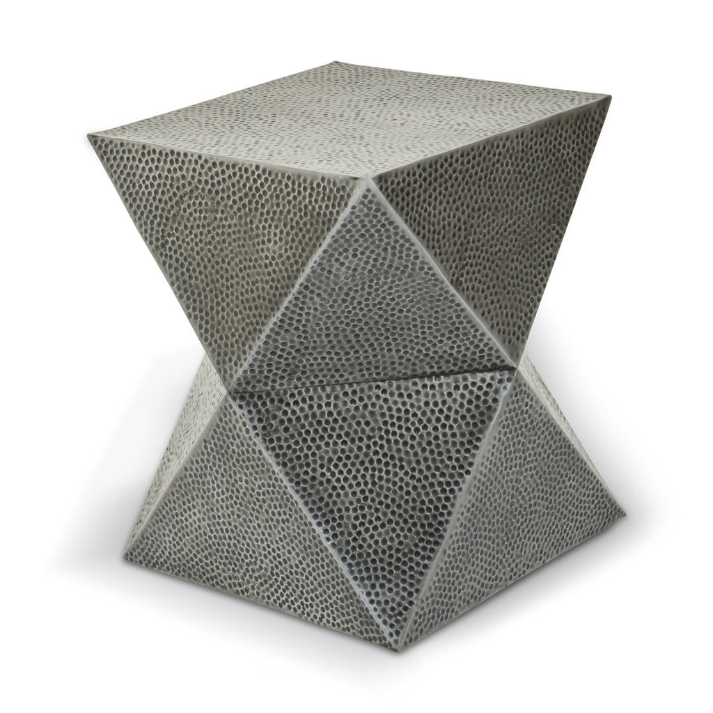 Geometric metal stool with a textured surface on a white background