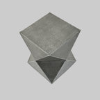 Geometric metal stool side table on a light gray background