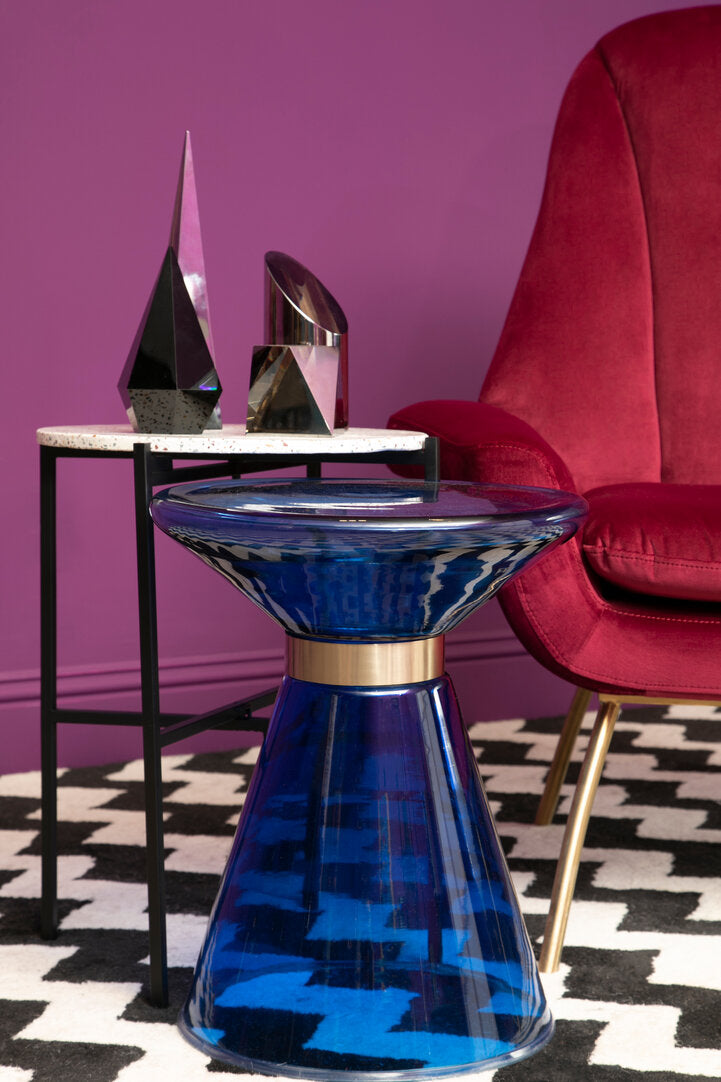Blue Glass Martini Side Table on geometric rug next to table and armchair