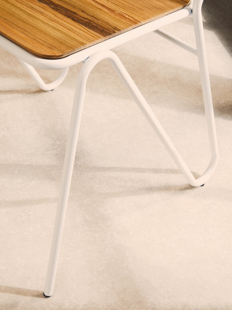 Chair with wooden seat and white metal frame on a light background