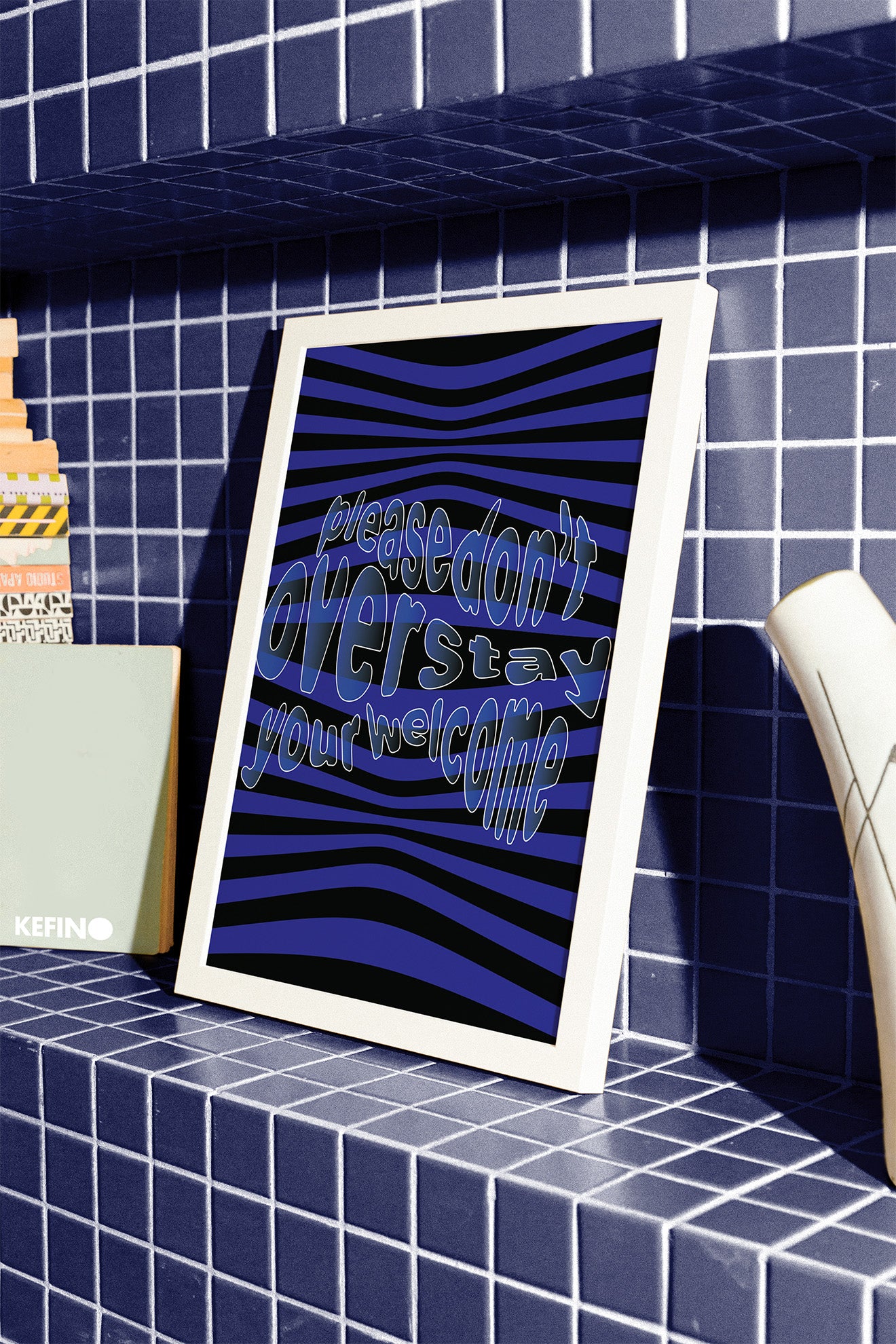 Please_dont_overstay_your_welcome_poster_in_white_frame_on_blue_tiles