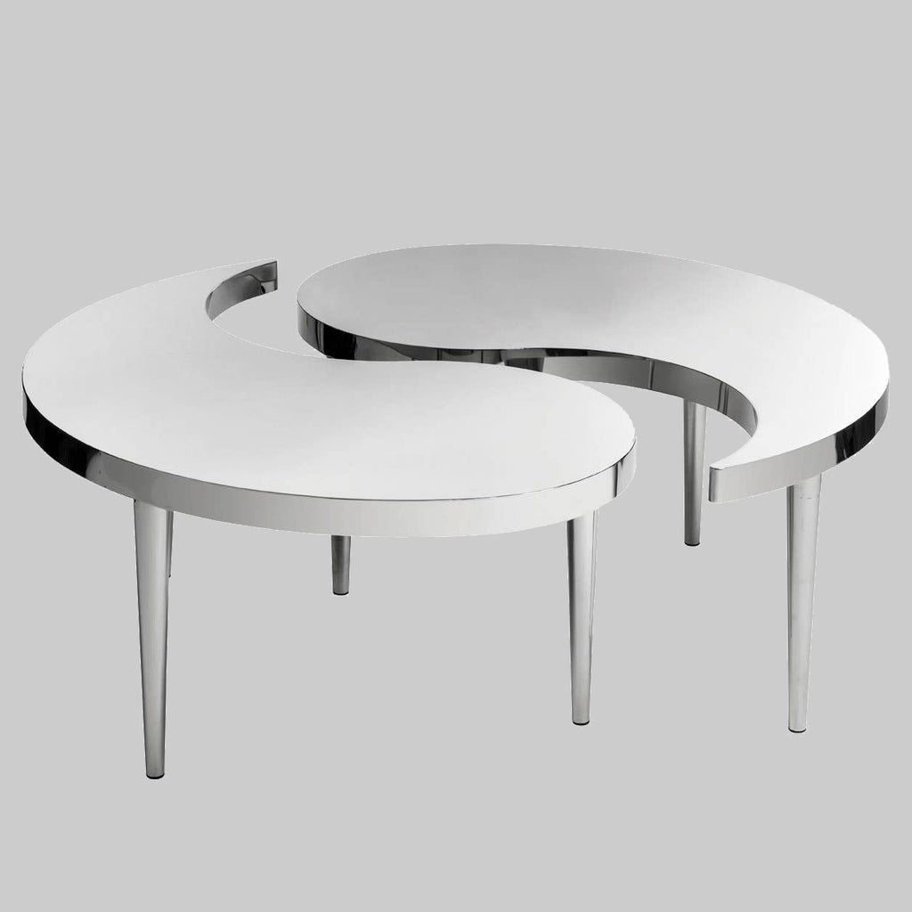 Two modern, round tables with chrome legs on a gray background