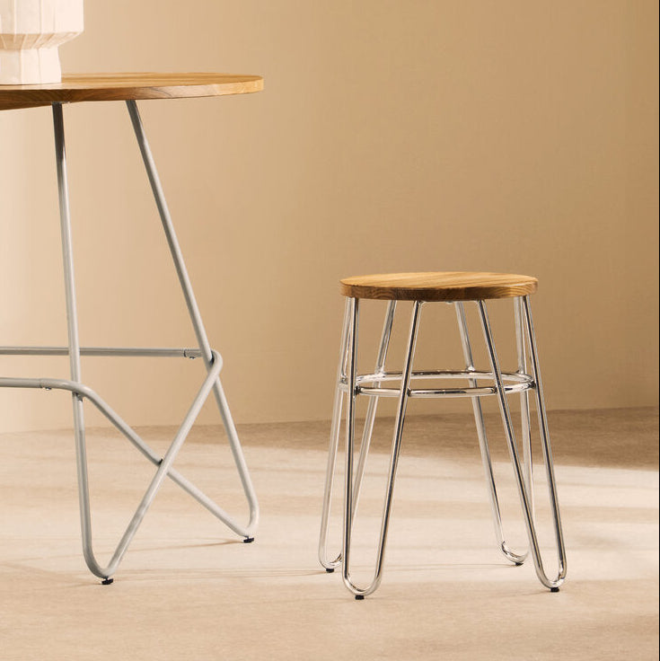 Wooden table and stool with metal legs on a beige background