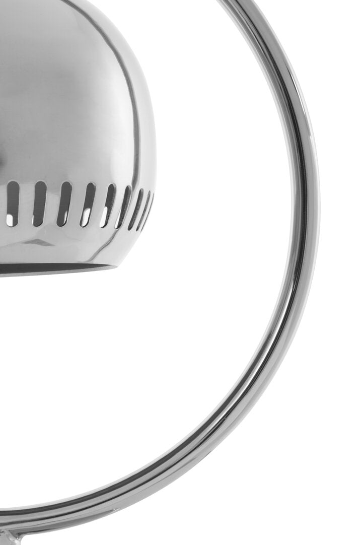 Close-up of a metallic lamp shade with circular design on a white background