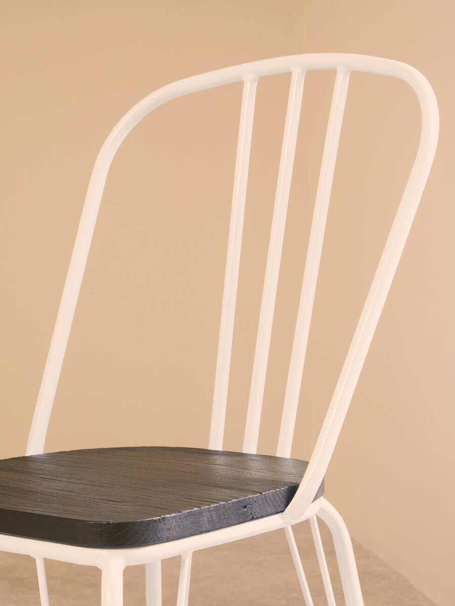 White metal chair with a dark wooden seat against a beige background