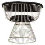 Modern chair with wireframe design and black velvet cushion on a white background