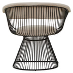 Black wired lounge chair with beige cushion on a white background