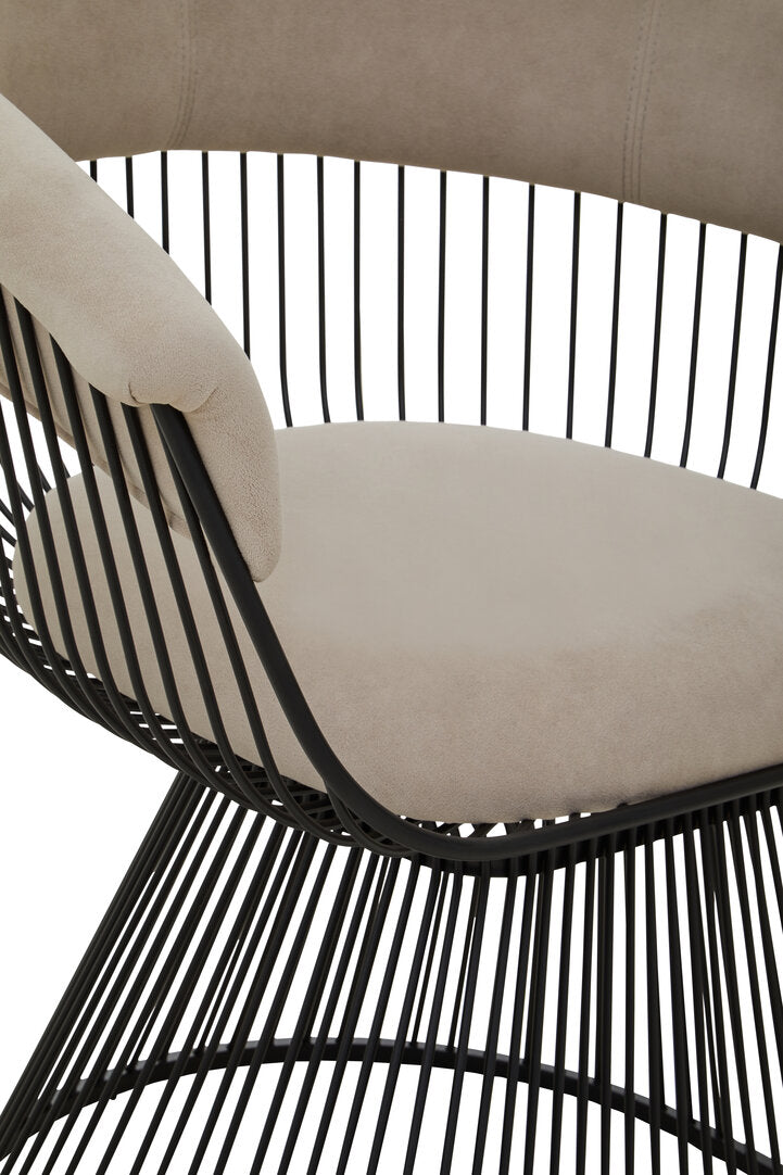 Beige cushioned chair with black metal wire frame on a white background