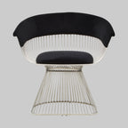 Modern chair with wireframe design and black cushion on a gray background