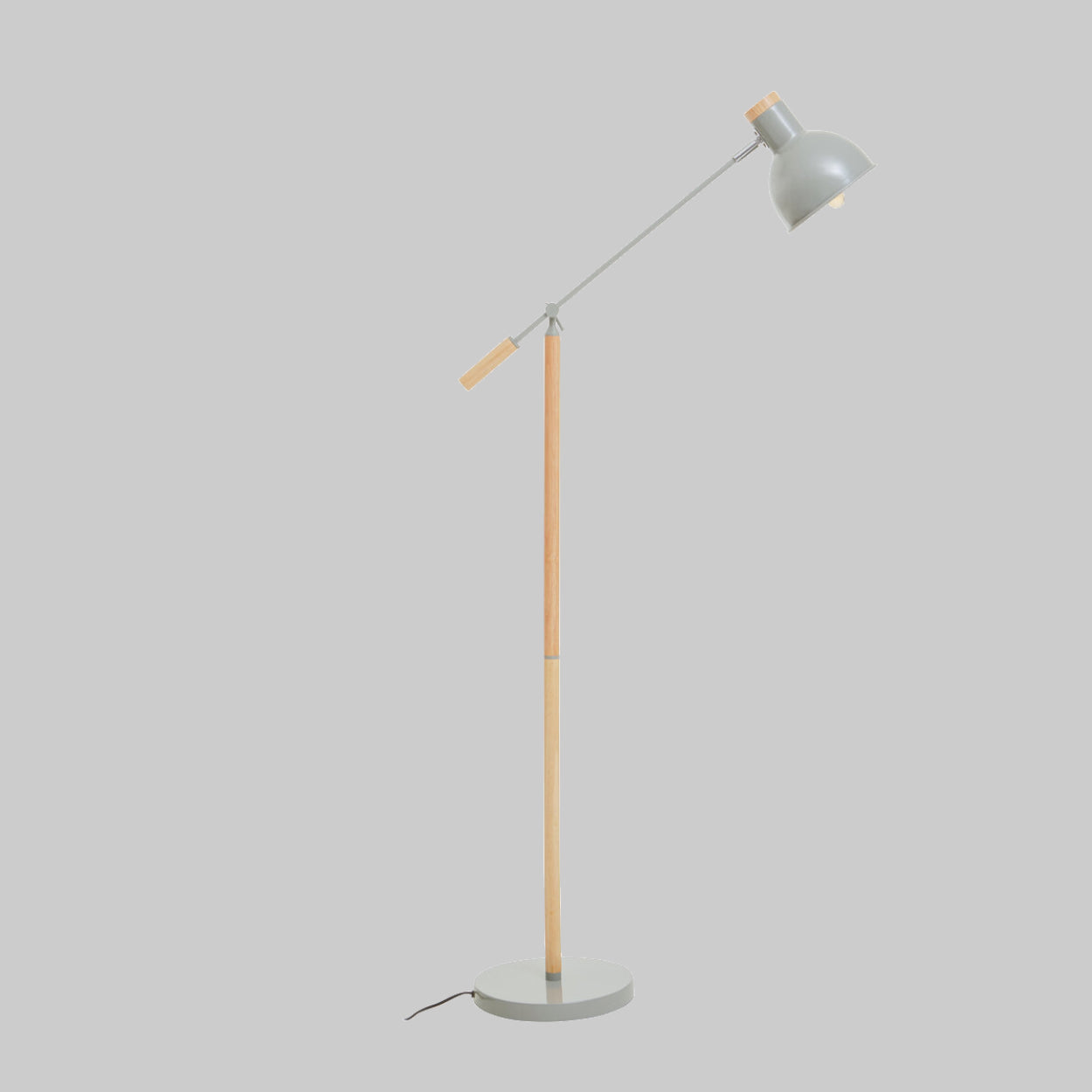 Floor lamp with a grey shade and wooden base on a light grey background