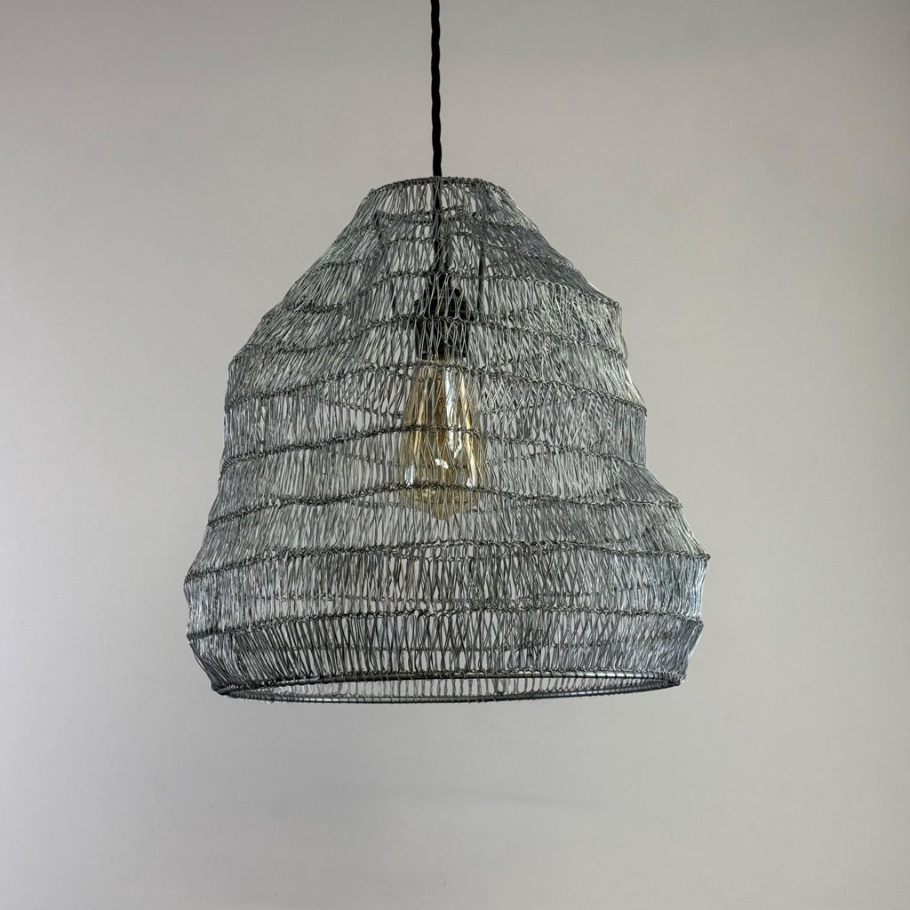Woven metal pendant light with a neutral background