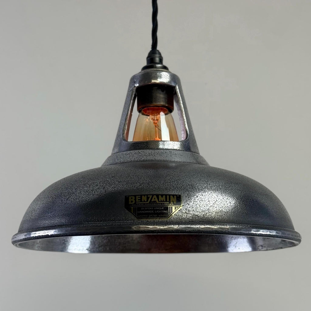 Industrial-style pendant light with a visible brand name on a grey background